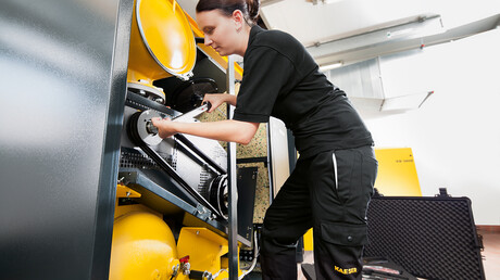 Service technician checking a compressor in the water management industry.